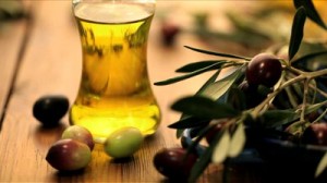 stock-footage-bottle-of-olive-oil-with-olives-rolling-in-foreground